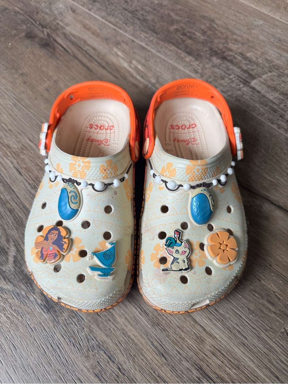 Disney Moana CROCS Kids Beige Clogs with Bright Orange Trim and Colorful Charms